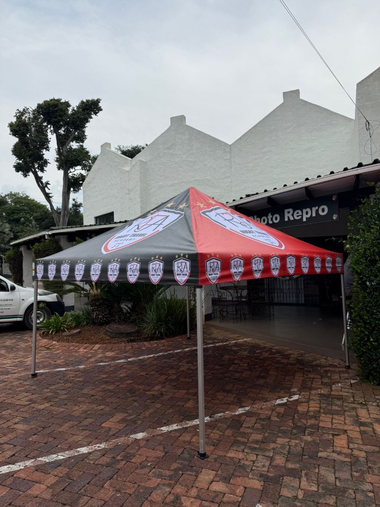 Red and black branded gazebo for Rugby Travel Academy by Plan Photo Repro